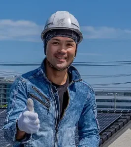 屋根の上でサムズアップするサンテクペイントのスタッフ